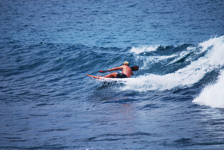 Man surfing on boat in sea