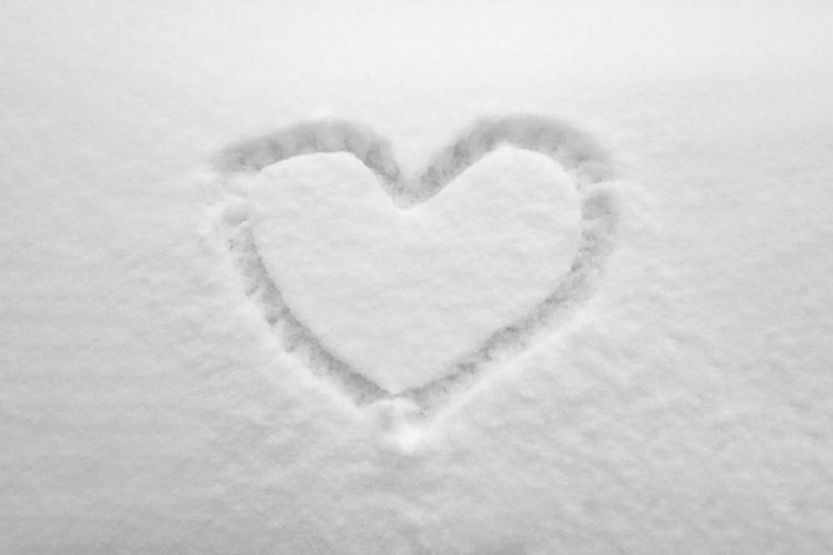 Close-up of heart shape in snow