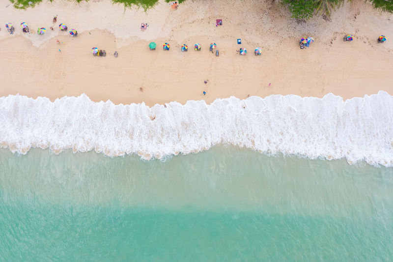 The sea wave on the beach and tourist aerial view at surin beach phuket thailand
