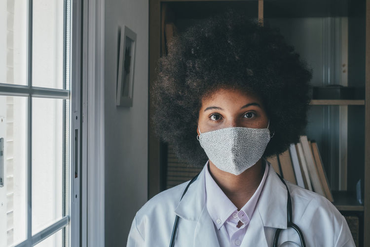 Portrait of doctor wearing flu mask at hospital