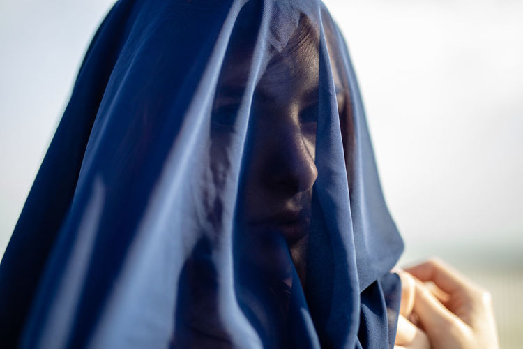 Close-up of woman covered with navy blue textile