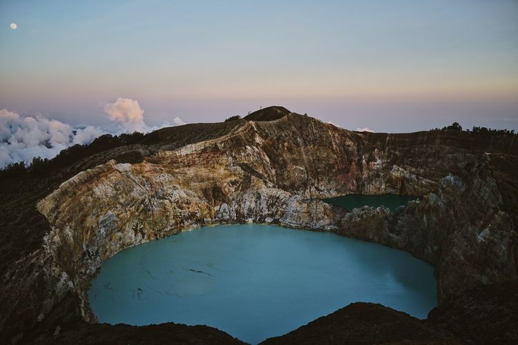 High angle view of volcano crater against sky during sunset