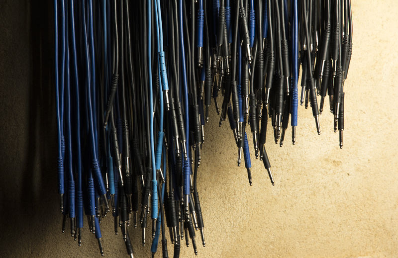 Close-up of cables hanging against wall
