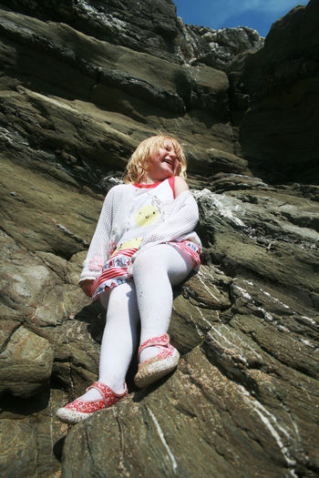 Girl sitting on rock