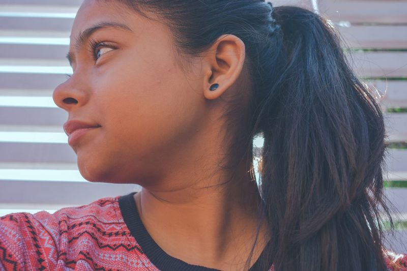 Close-up of young woman looking away