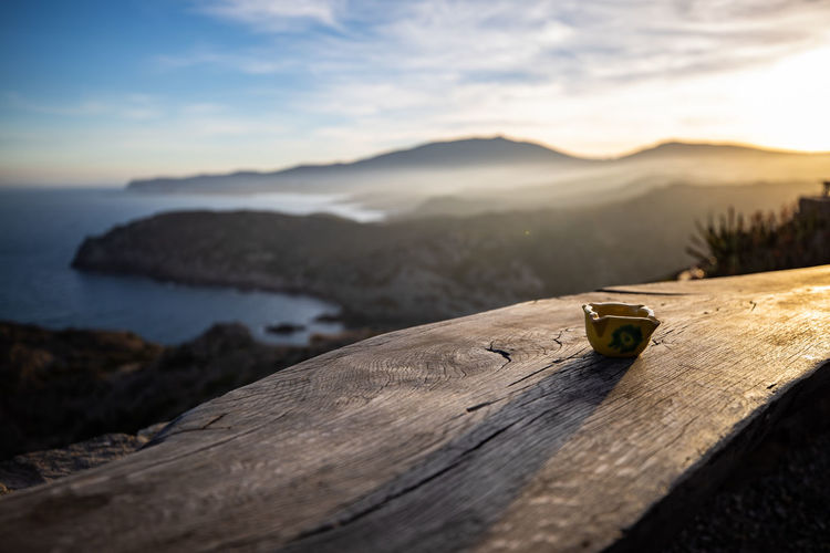 Scenic view of sea by mountains against sky