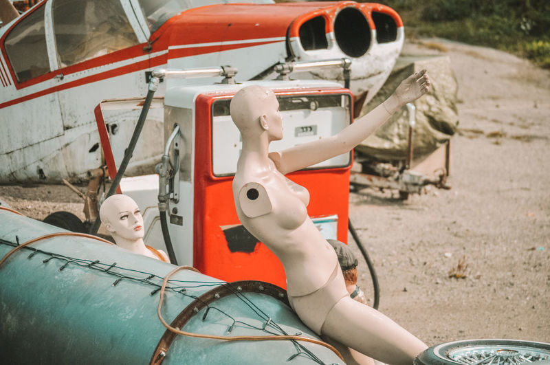 Side view of a  manikin and junk car