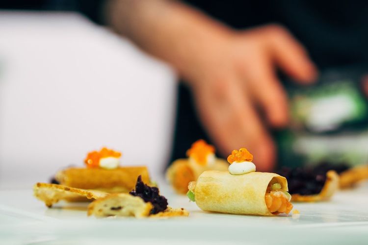 Close-up of appetizer served on table with man in background