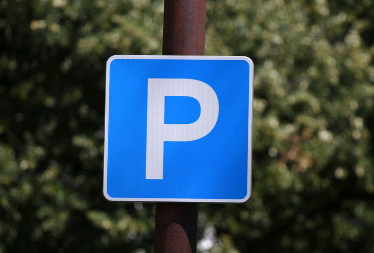 Close-up of parking sign on pole