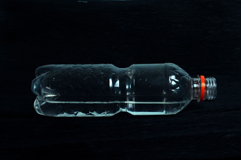 Close-up view of bottle against black background