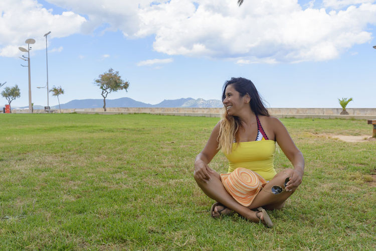 Portrait of a latin woman smiling, on vacation in mallorca posing  a summer day, vacation concept