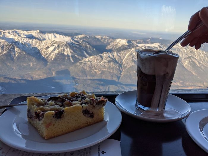 High angle view of ice cream in glass on table with alps in the background