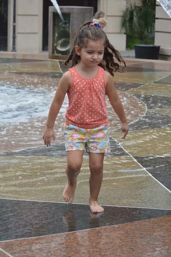 Full length of girl playing in water