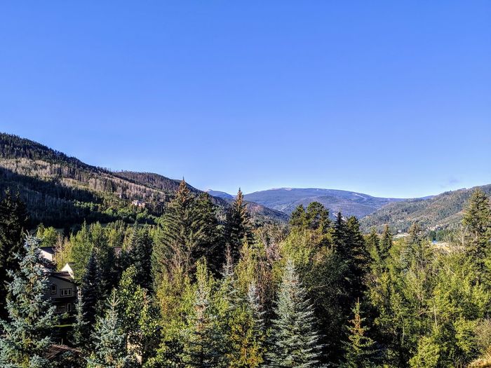 Scenic view of mountains against clear blue sky