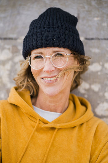 Happy mature woman wearing knit hat