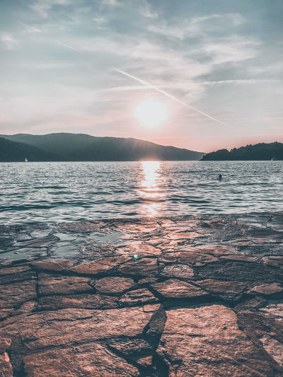 Scenic view of lake against sky during sunset