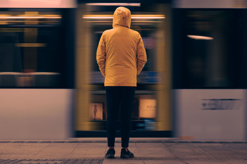 Rear view of man walking in subway
