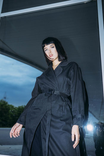 Fashionable portrait of a woman in a black cloak
