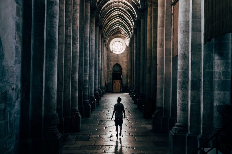 Silhouette man walking in church 