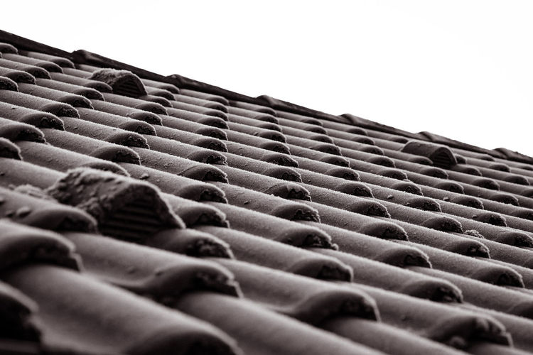 Low angle view of roof tiles against clear sky