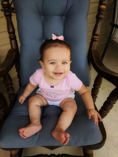 High angle portrait of cute baby girl sitting on rocking chair