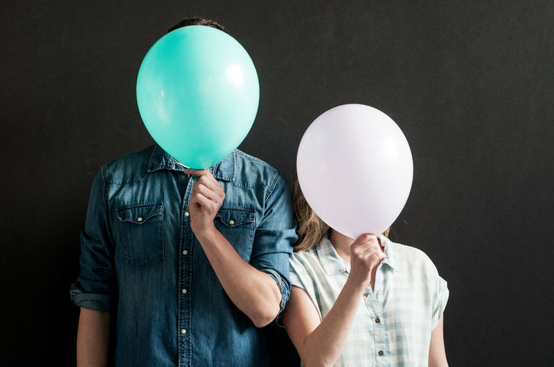 Portrait of people holding balloons