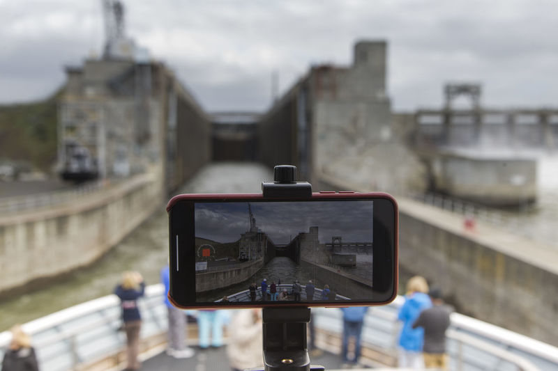 A cell phone records a timelapse of a ship going through a lock.