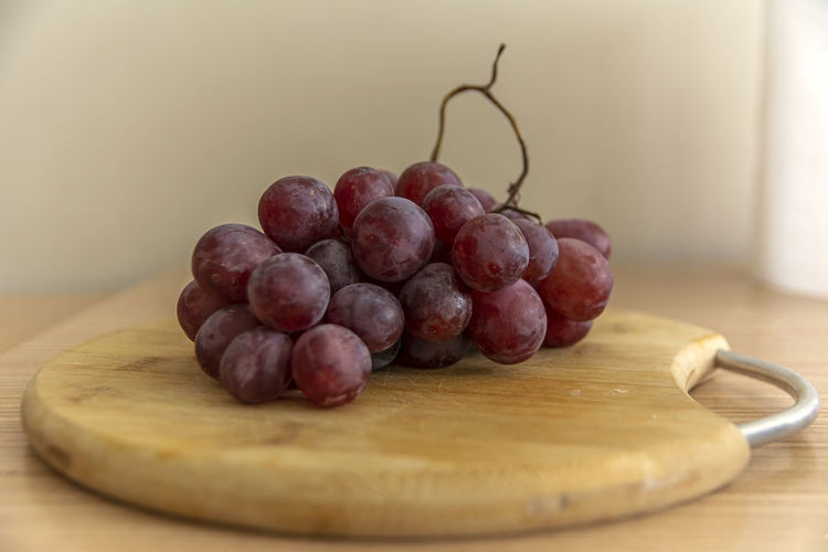 Close-up of grapes in container on table