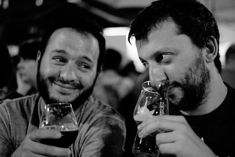 Smiling friends having beer in bar