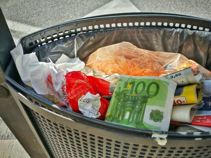 Artificial currency in wastepaper basket