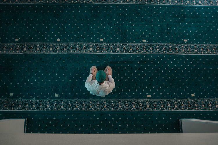 High angle view of people sitting by swimming pool