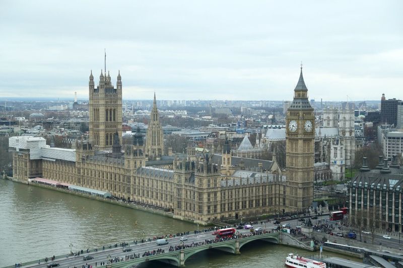 High angle view of big ben by river thames against sky in city