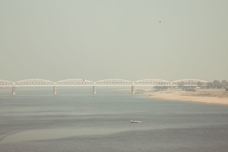 View of bridge over sea against clear sky
