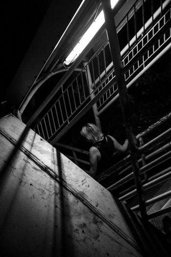 High angle view of person sitting on staircase in building