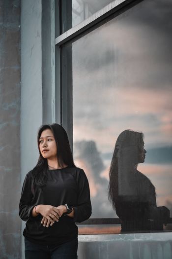 Portrait of young woman using mobile phone