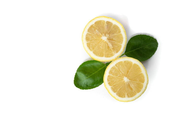 Close-up of lemon slice over white background