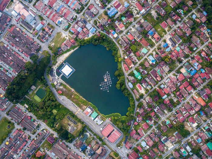 Aerial view of lake amidst houses in town