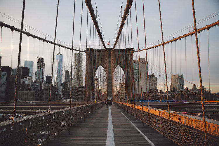 Brooklyn bridge against cloudy sky