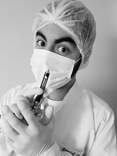 Close-up portrait of male surgeon holding medical equipment in hospital