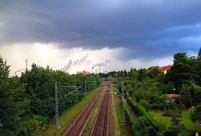 High angle view of railroad tracks against storm clouds