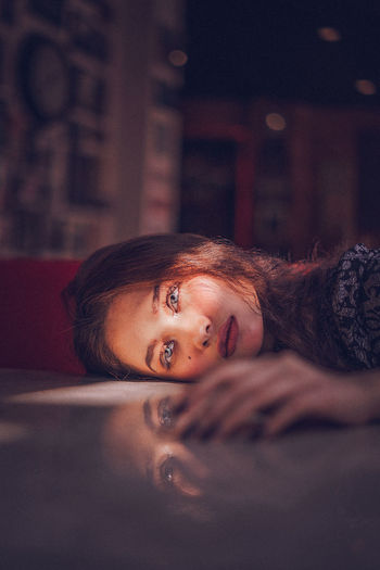 Portrait of woman lying on floor
