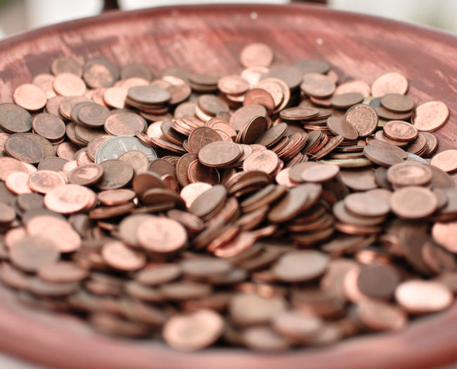 Close-up of coins in container