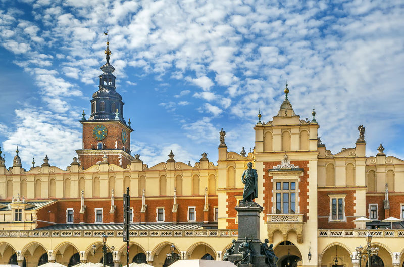 Krakow cloth hall and adam mickiewicz monument on main square in krakow, poland