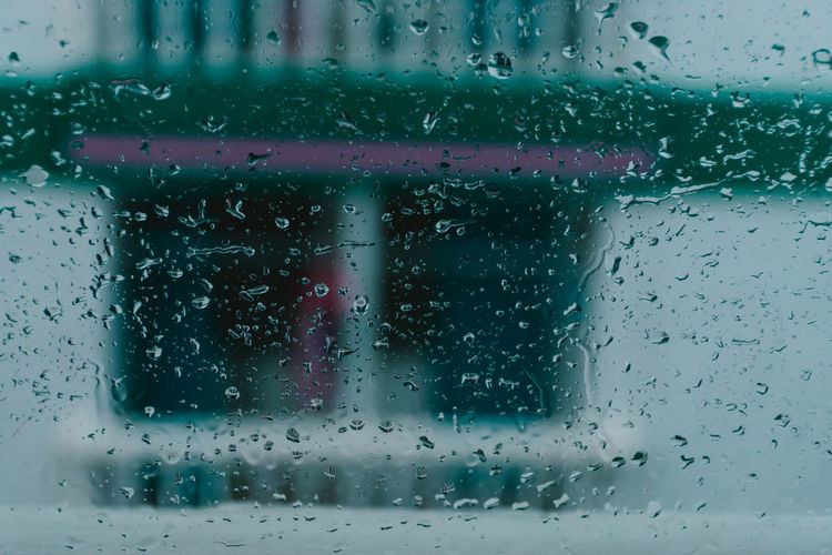 Full frame shot of wet glass window in rainy season