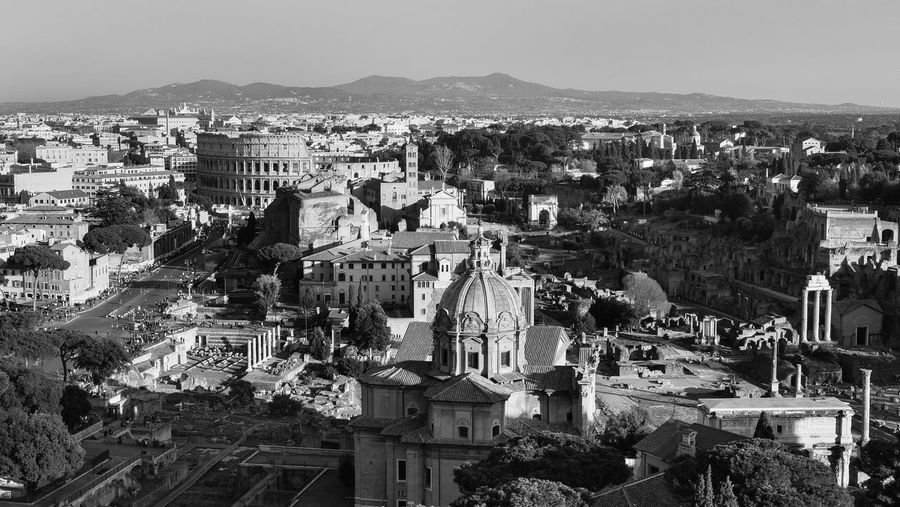 Rome with his famous places amphitheater colosseum, ruins of roman forum. black and white photo.