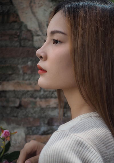 Close-up portrait of a young woman looking away
