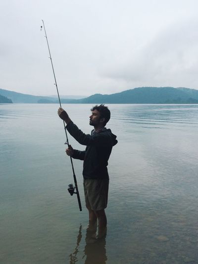 Man fishing in shallow water