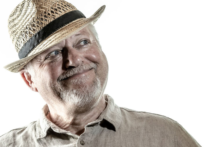 Portrait of man wearing hat against white background