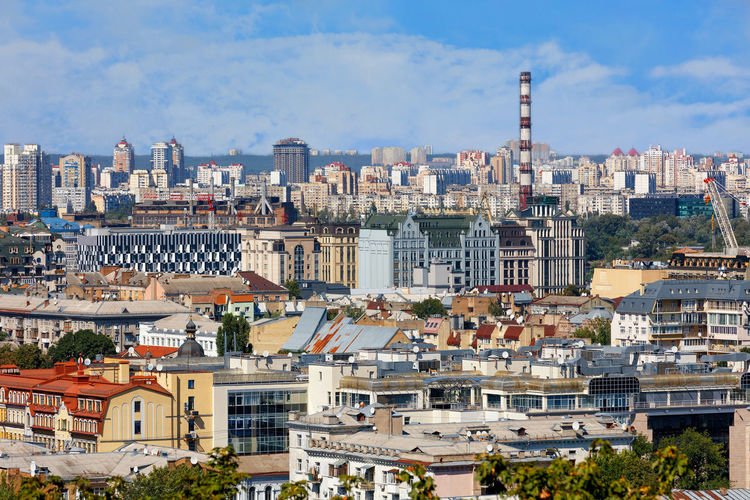 The landscape of summer kyiv with a view of the old district of podil with dense development.