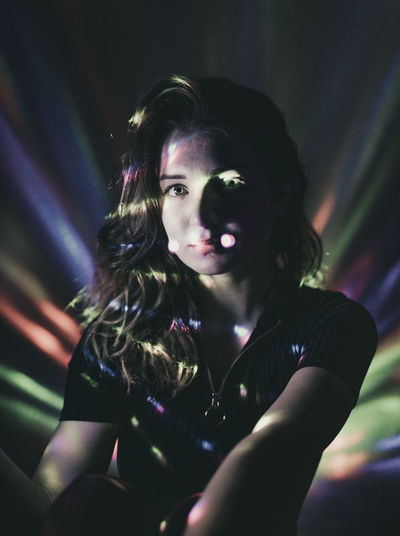 Portrait of woman in illuminated nightclub